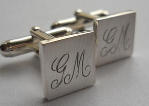 initials hand engraved onto a set of cufflinks- this message R160